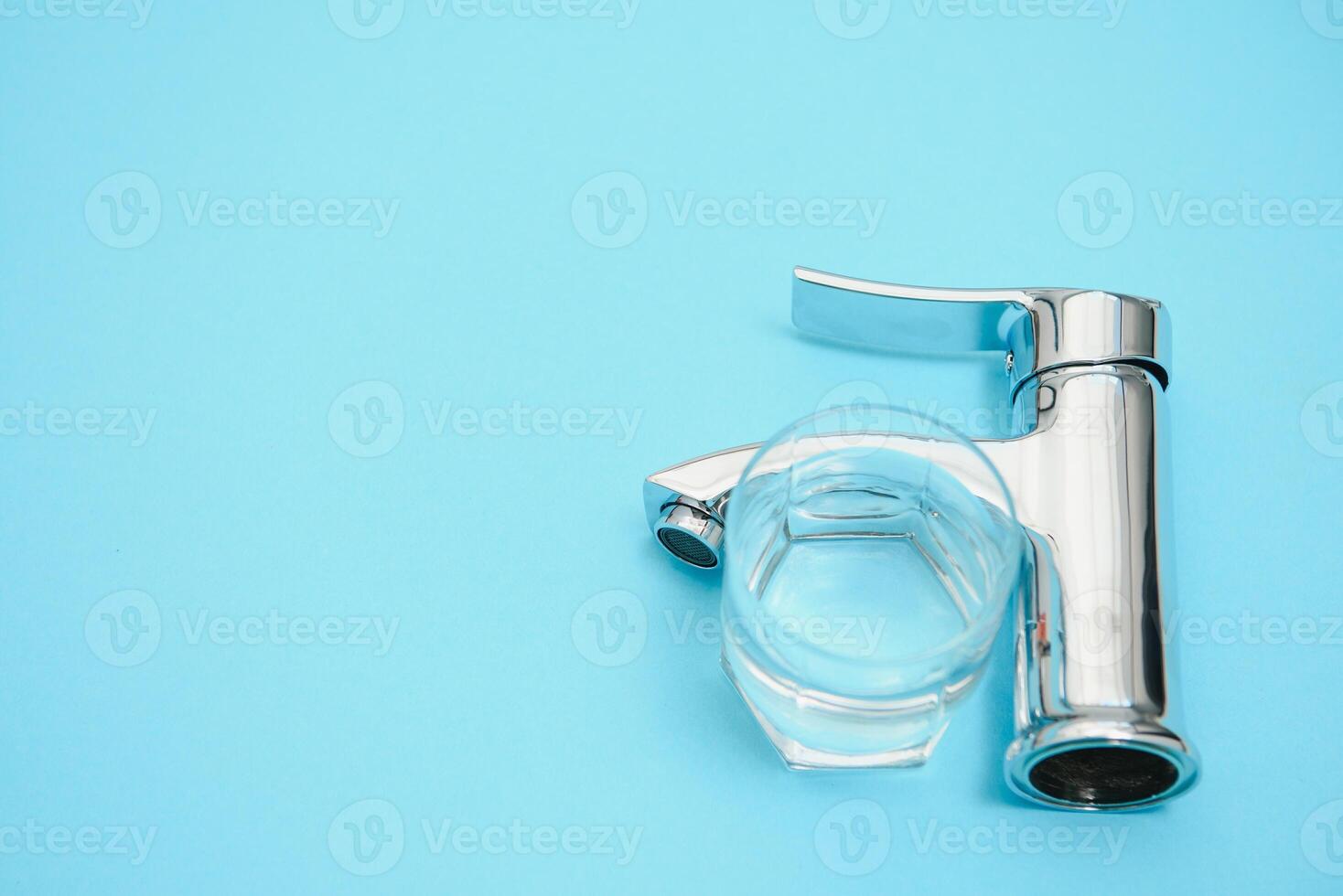 Single handle water tap on light blue background, closeup photo