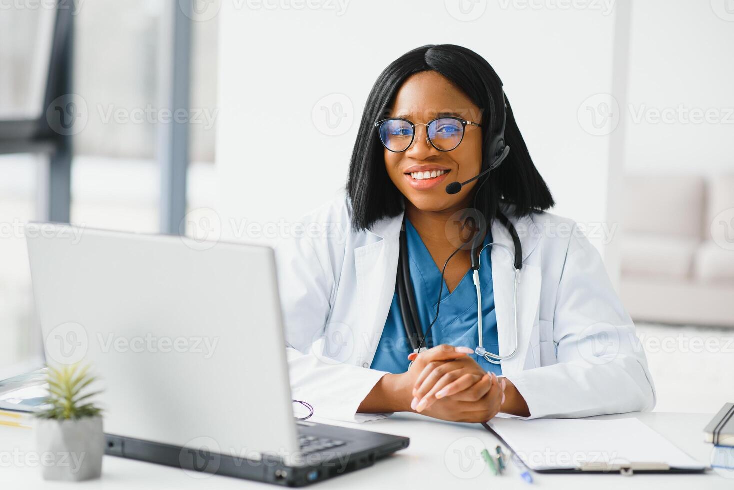 African American doctor working in her office at clinic. photo