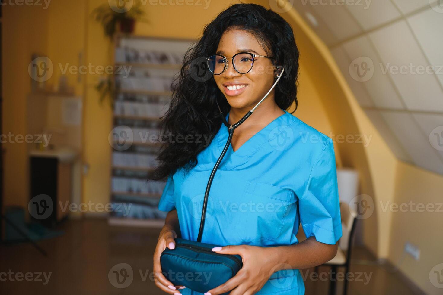 pretty female african doctor with arms crossed at hospital photo