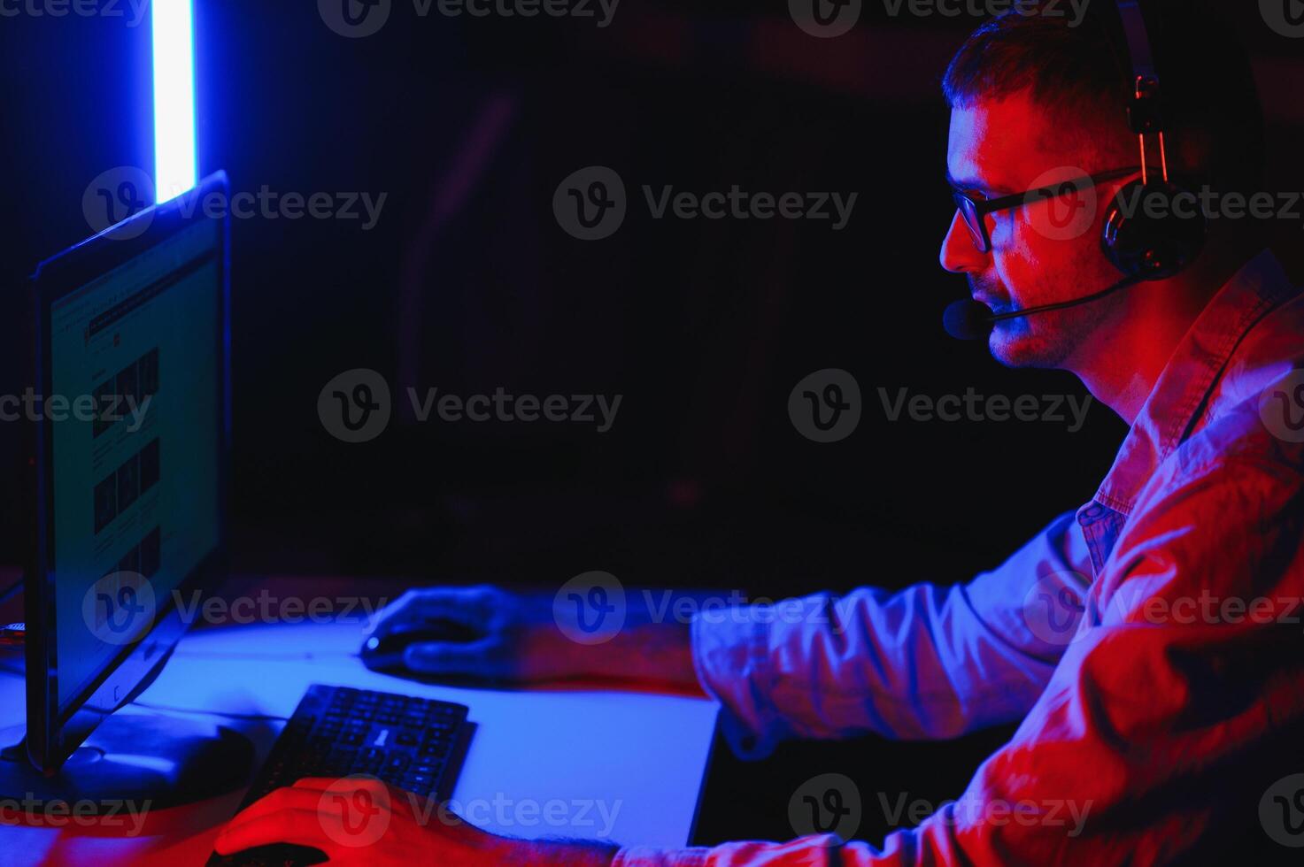 young man playing computer games on line photo