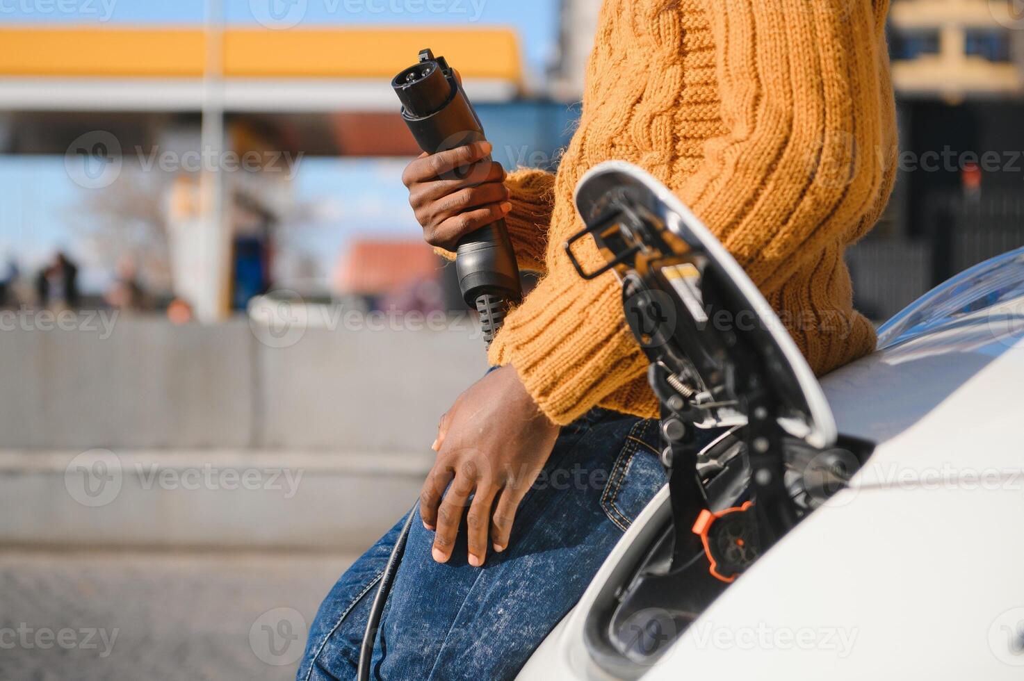 Man turning on charging of car photo