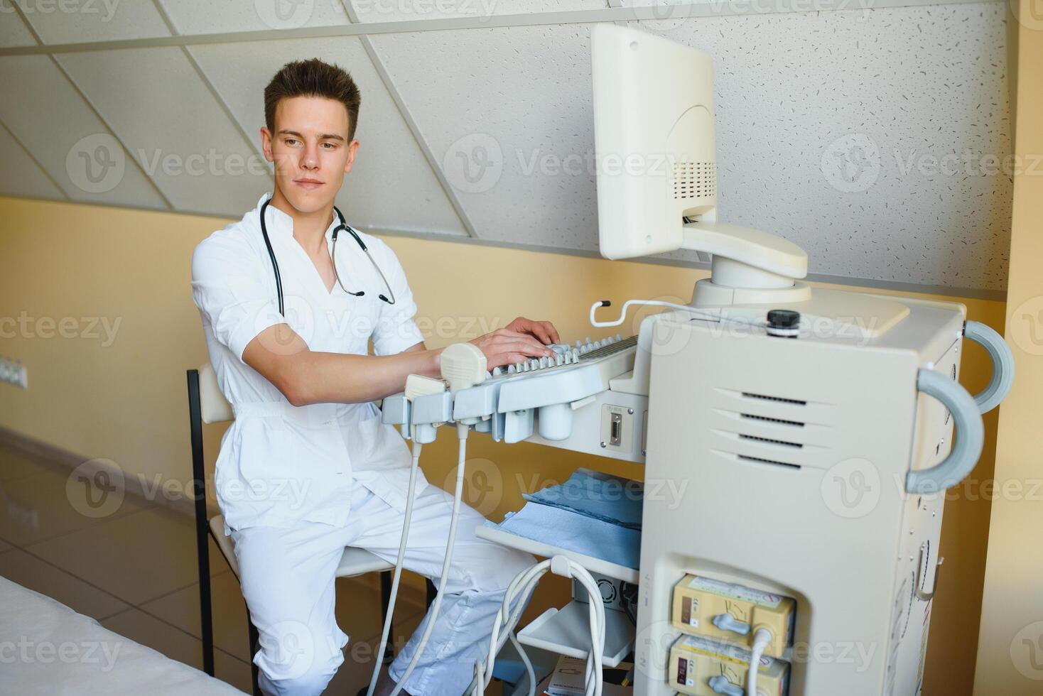 Sonographer operating modern ultrasound machine in clinic photo