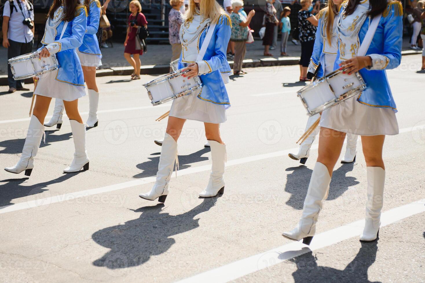 group of majorettes parade through the streets of the city photo