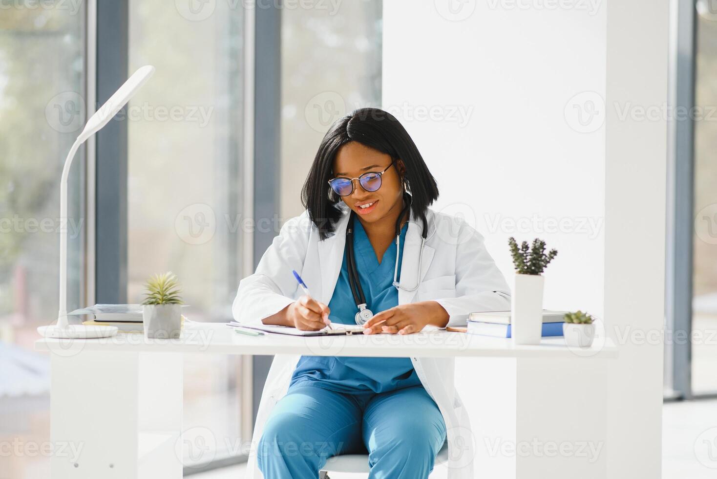 Portrait of African American woman doctor smiling in hospital. photo