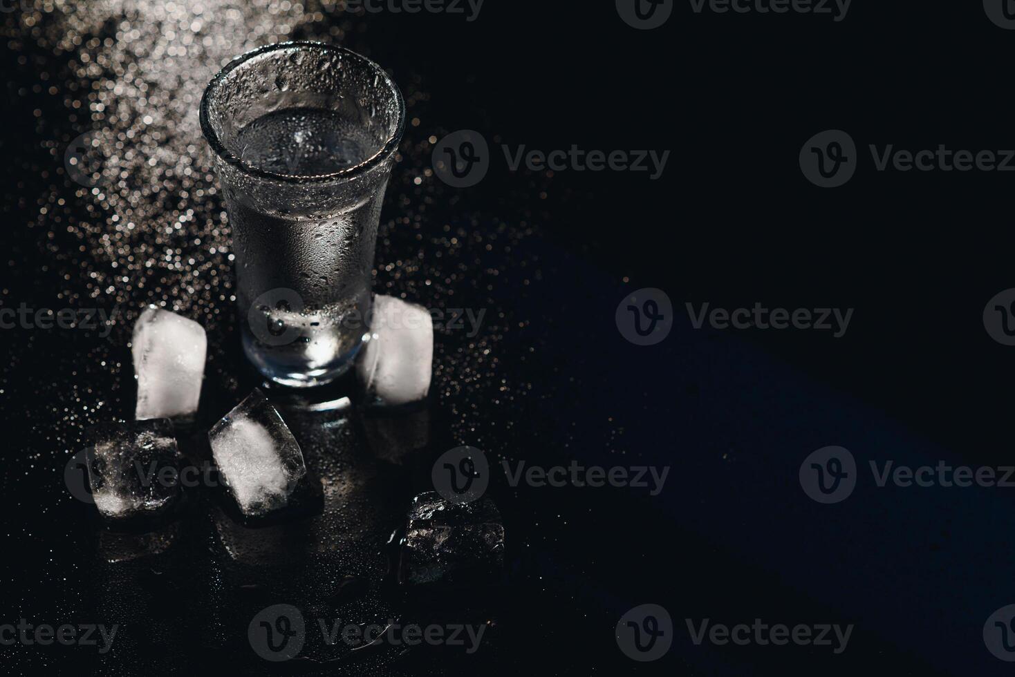 Vodka. Shots, glasses with vodka with ice .Dark background. Copy space .Selective focus. photo