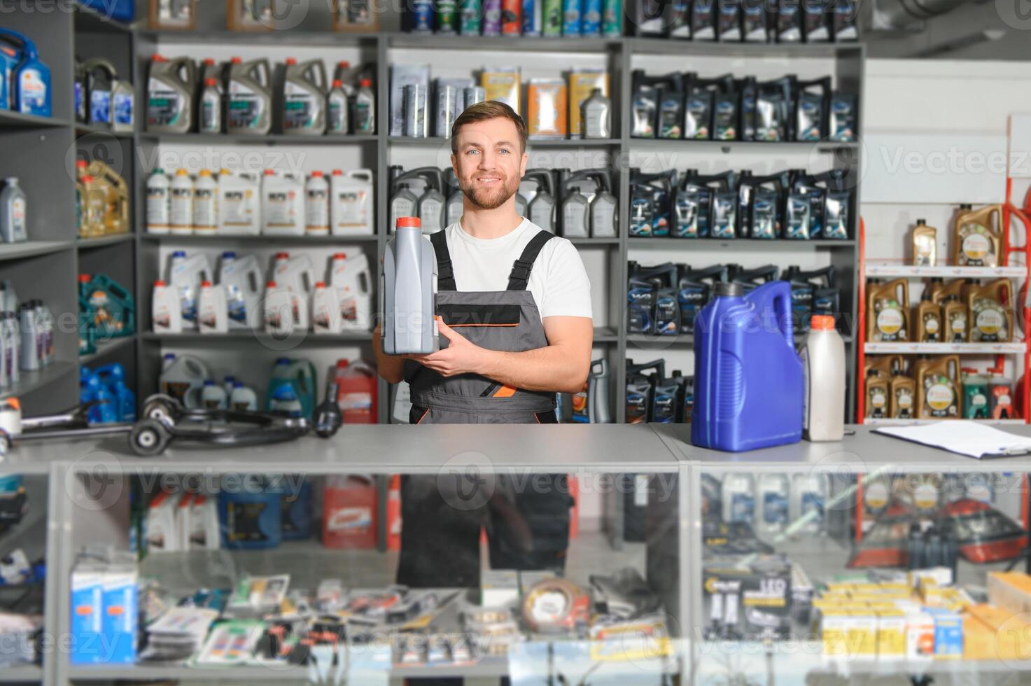 A salesman in an auto parts store. Retail trade of auto parts photo