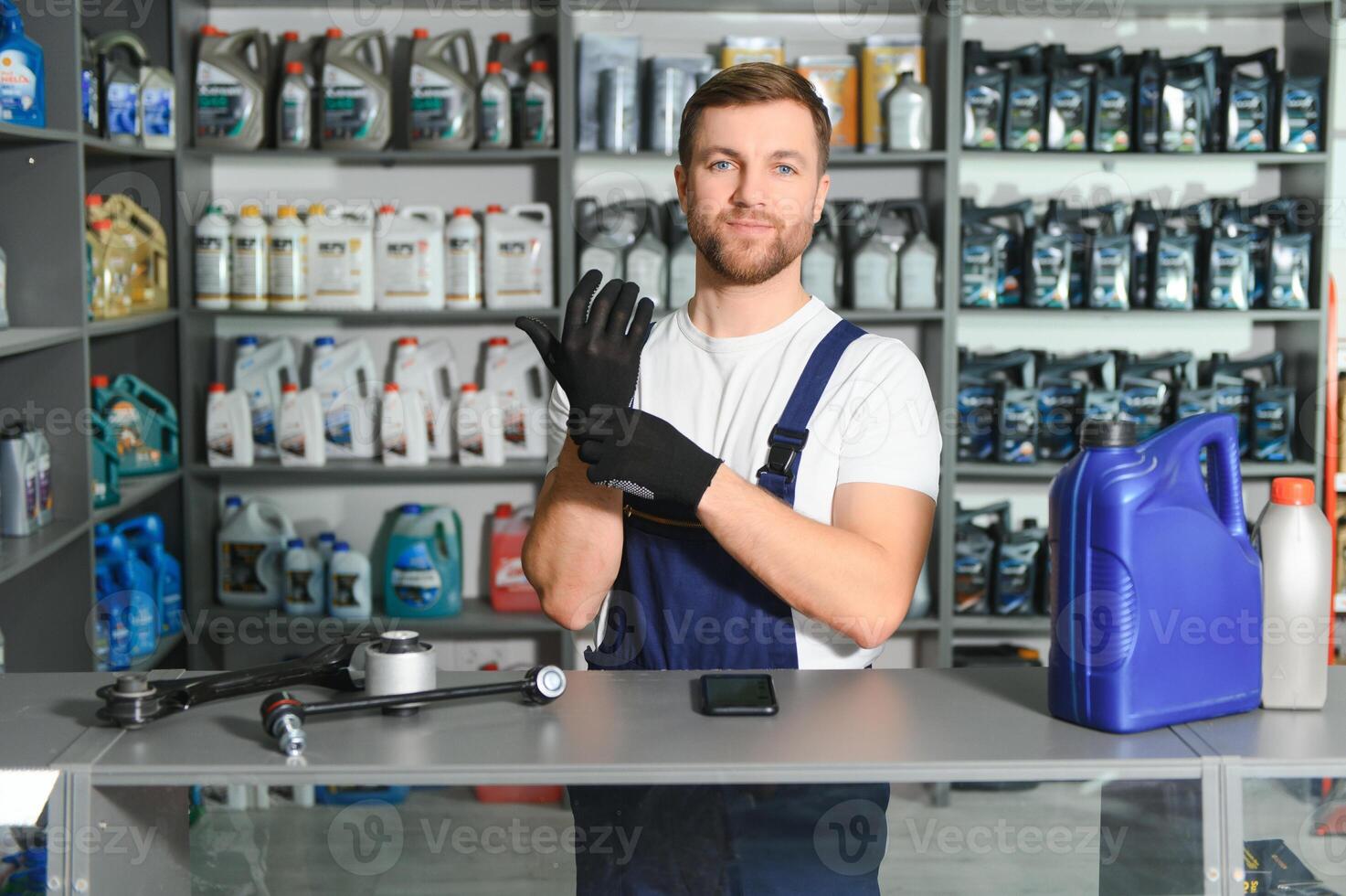 A salesman in an auto parts store. Retail trade of auto parts photo