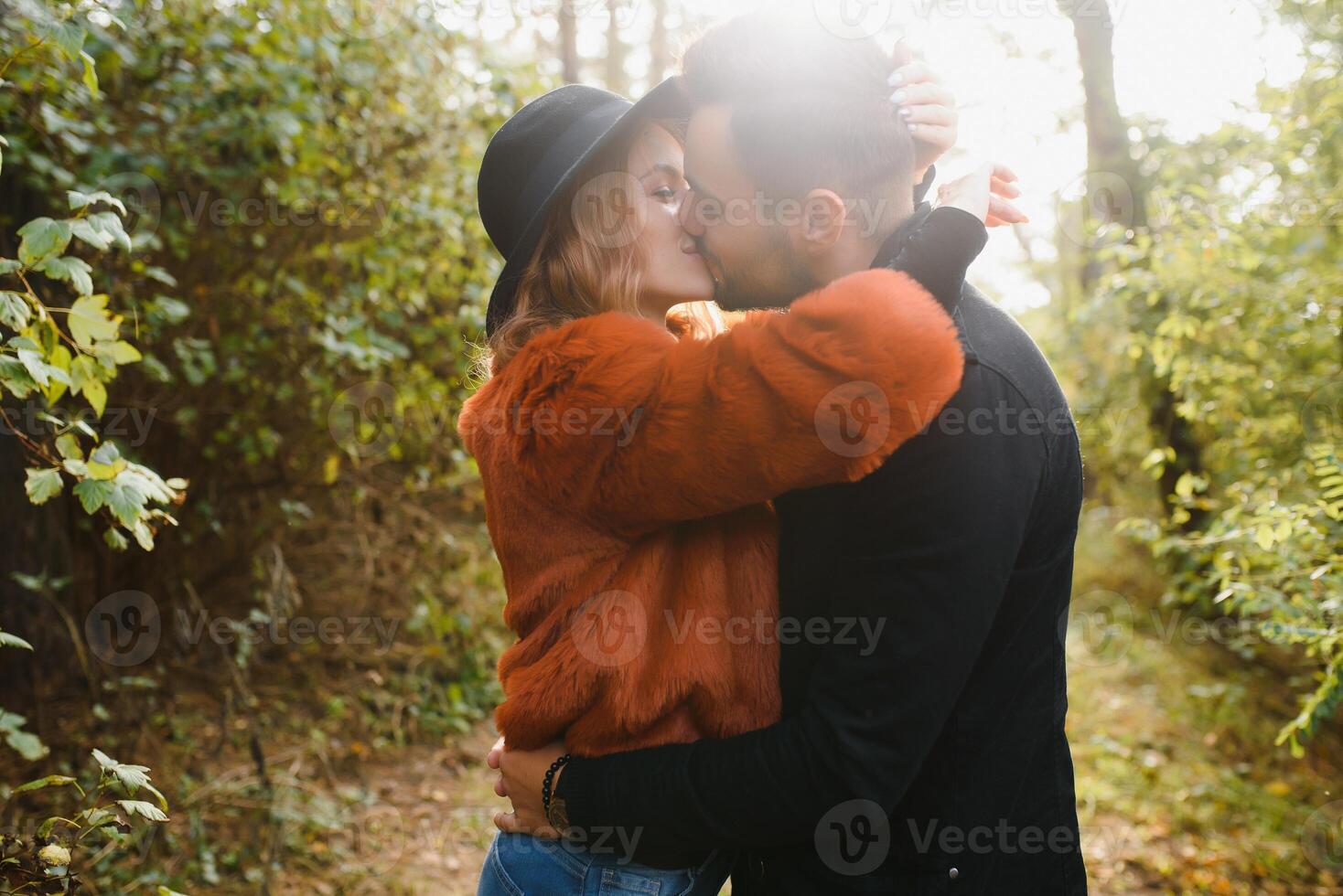 Kissing young couple in love in the autumn park. photo