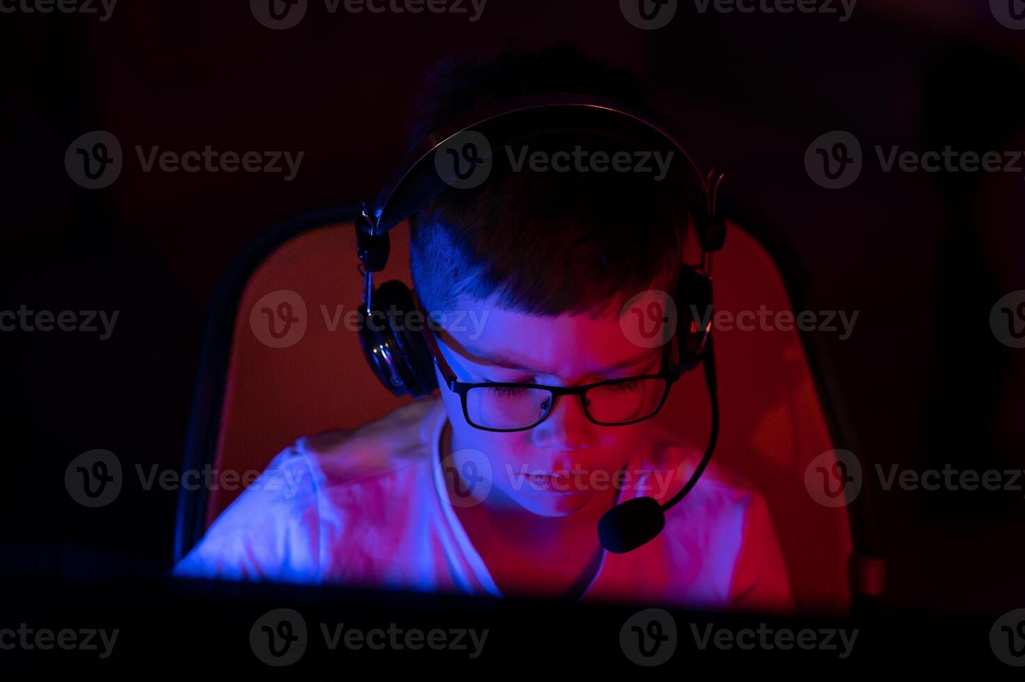 young man playing computer games on line photo