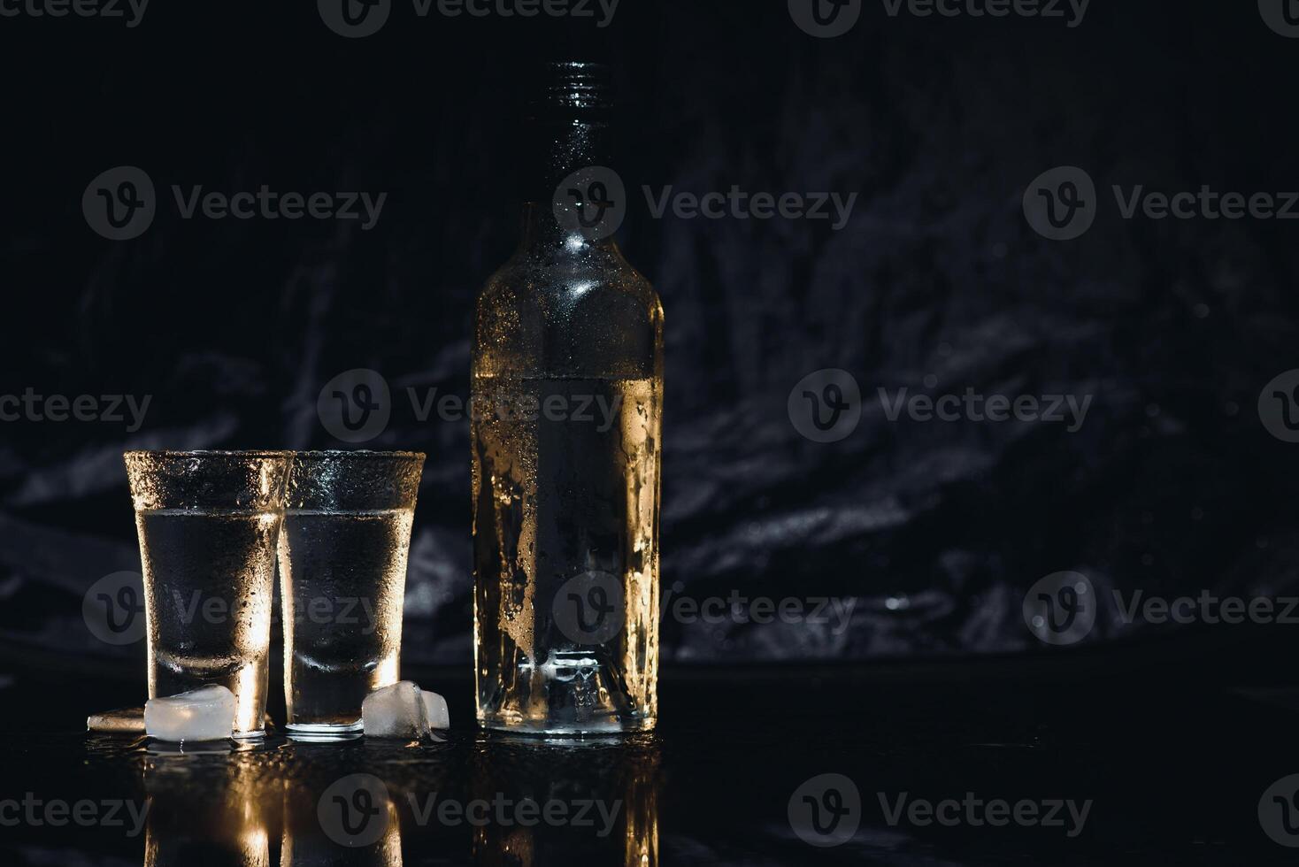 Vodka. Shots, glasses with vodka with ice .Dark background. Copy space .Selective focus. photo