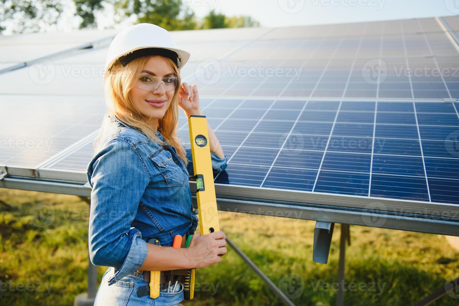 smiling engineer and solar panel background photo