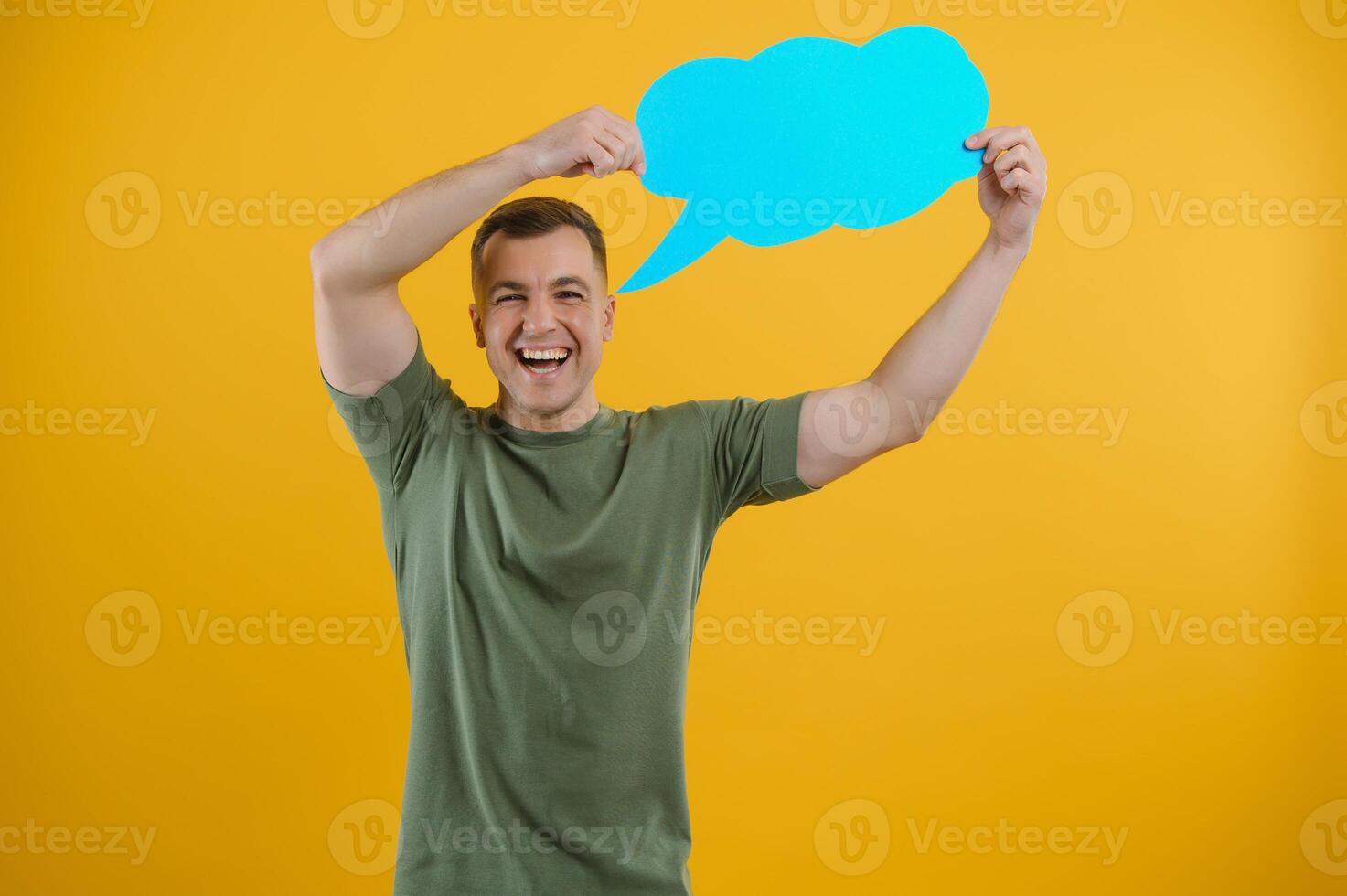 Young caucasian man isolated on yellow background holding a thinking speech bubble and doing OK sign photo