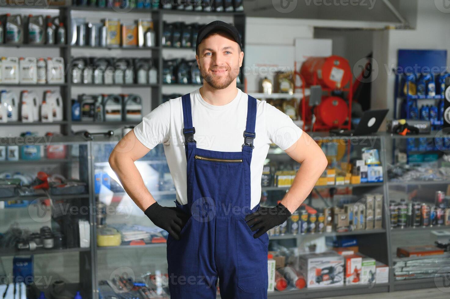 A salesman in an auto parts store. Retail trade of auto parts photo