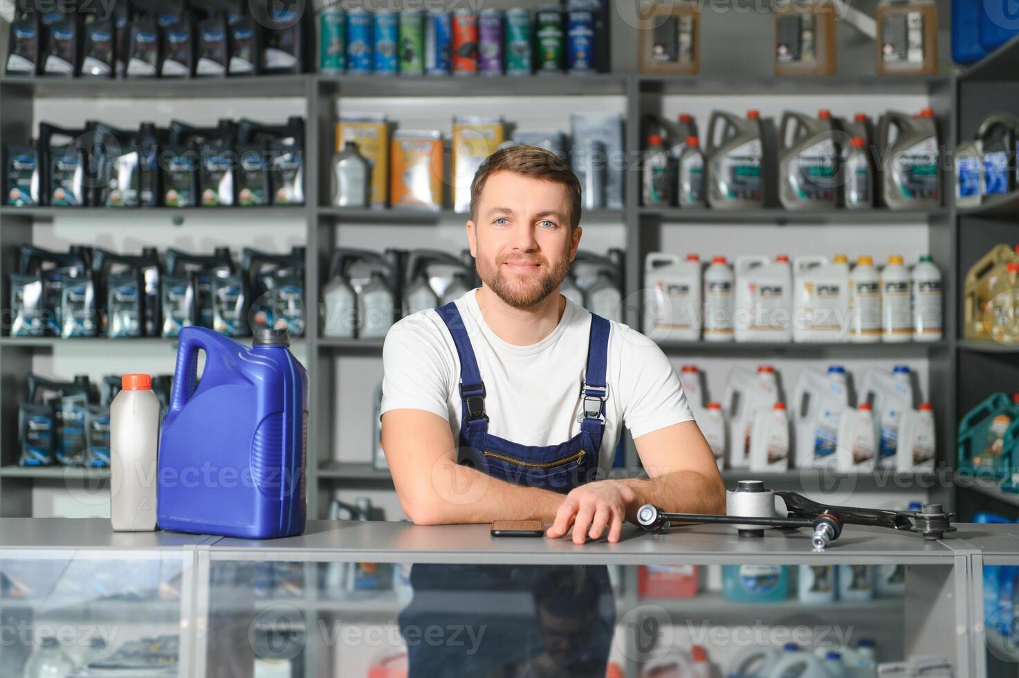 A salesman in an auto parts store. Retail trade of auto parts photo