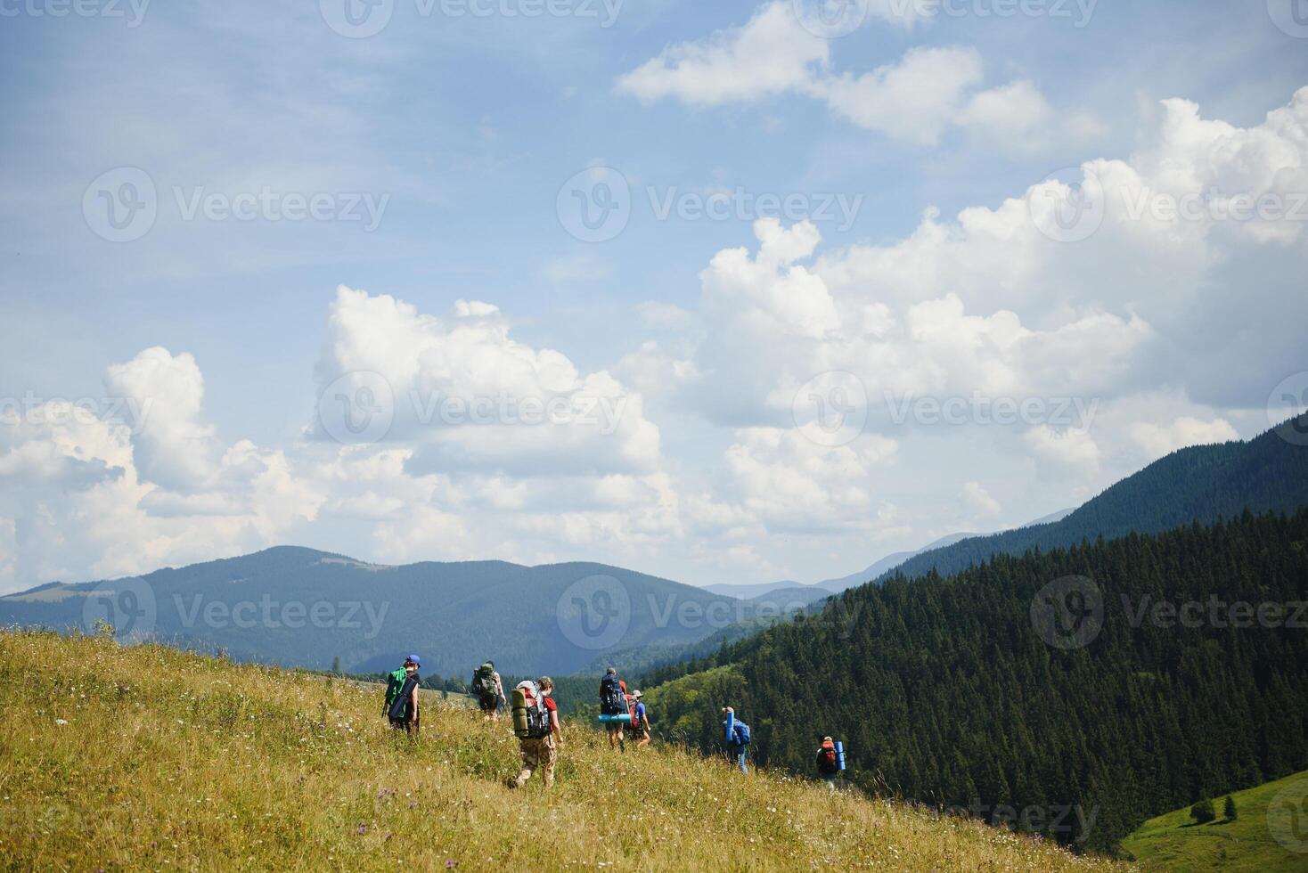 Group of hikers walking on mountain photo