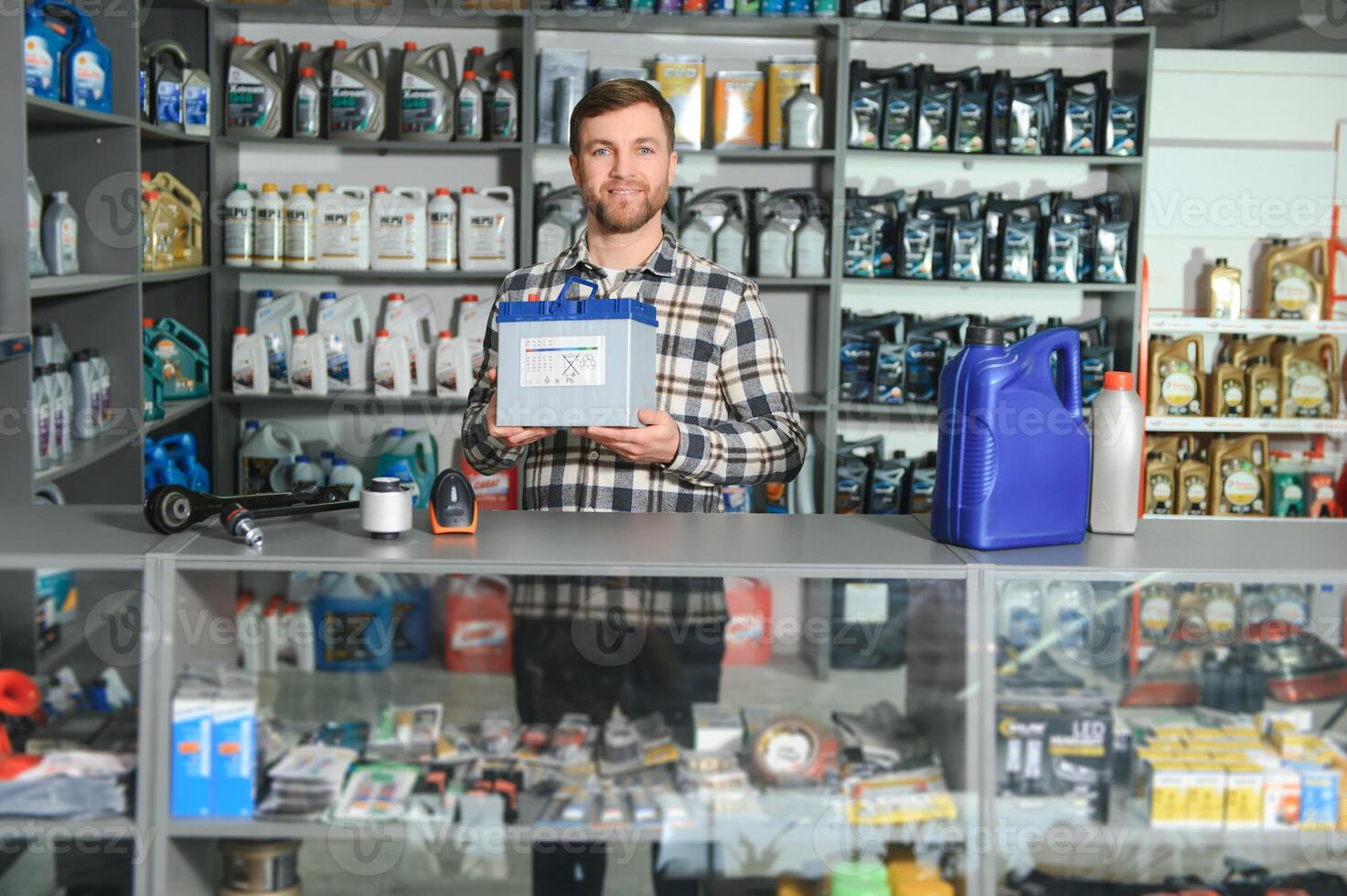 Portrait of a handsome salesman in an auto parts store. The concept of car repair photo