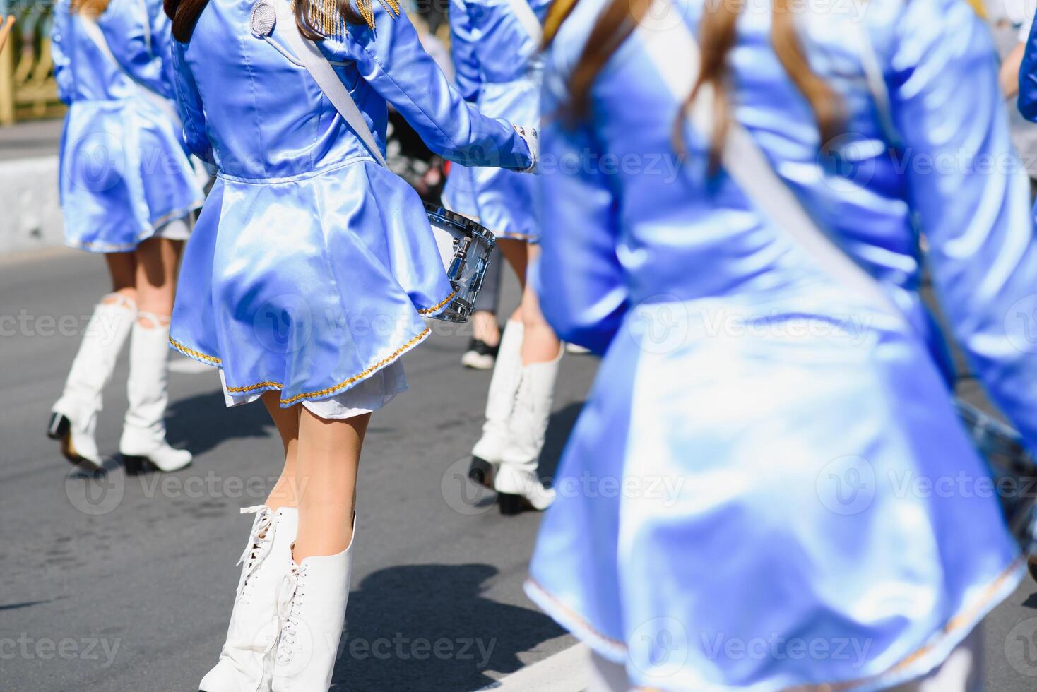 majorettes with white and blue uniforms perform in the streets of the city. photographic series photo