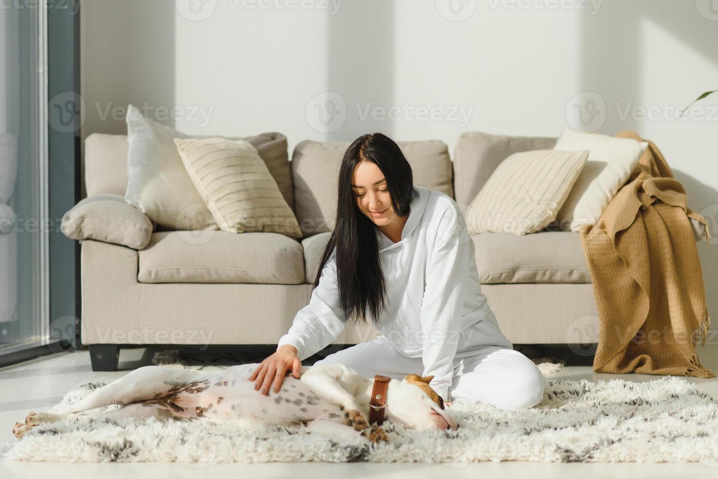 Young woman and her Golden Retriever at home. Adorable pet. photo