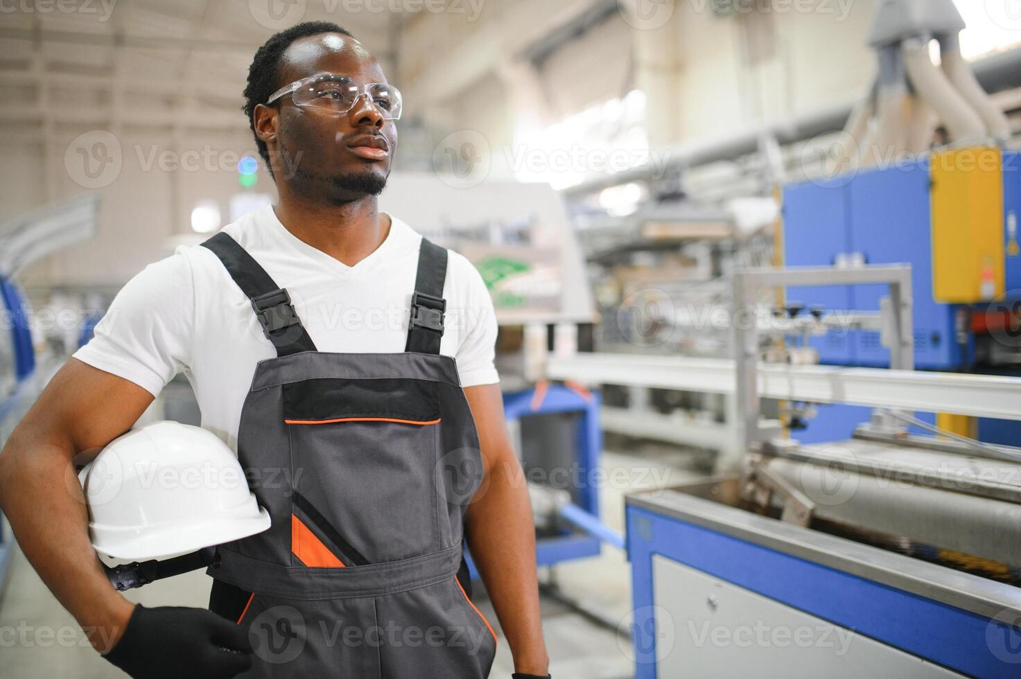 Portrait of industrial engineer. factory worker standing in factory production line photo