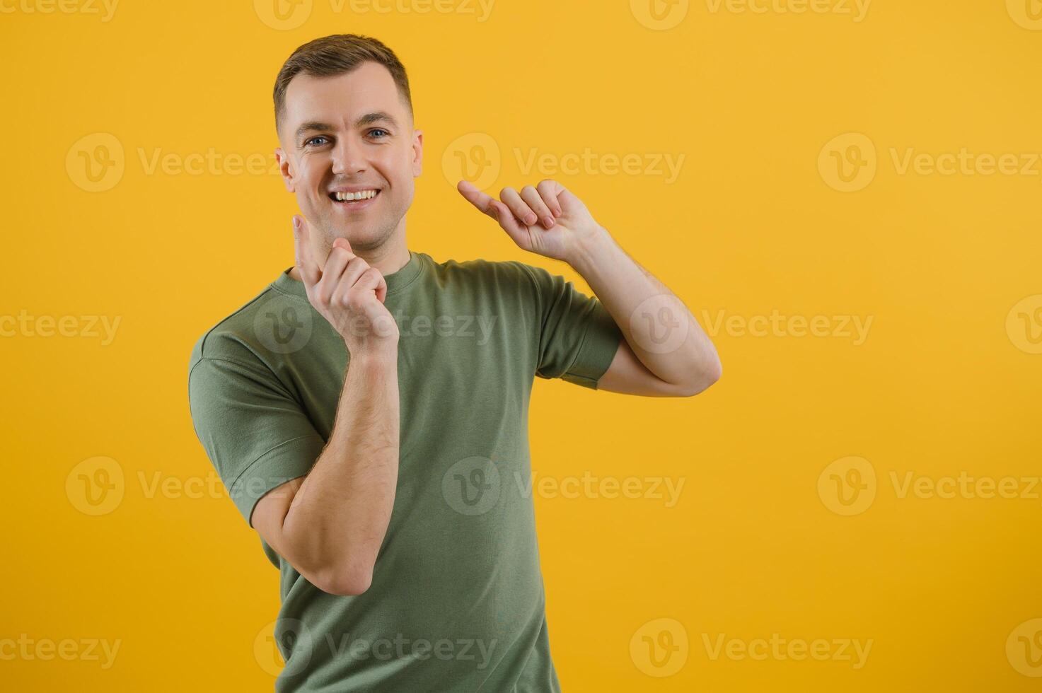 Wow, look at ads here Portrait of surprised shocked man pointing aside, showing blank copy space for idea presentation, commercial text. indoor studio shot isolated on yellow background. photo