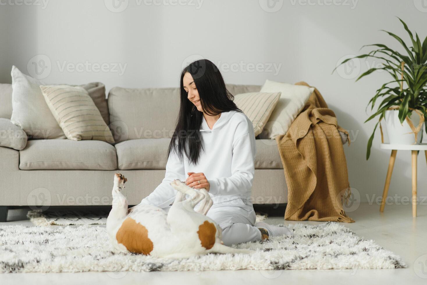 Young woman and her Golden Retriever at home. Adorable pet. photo
