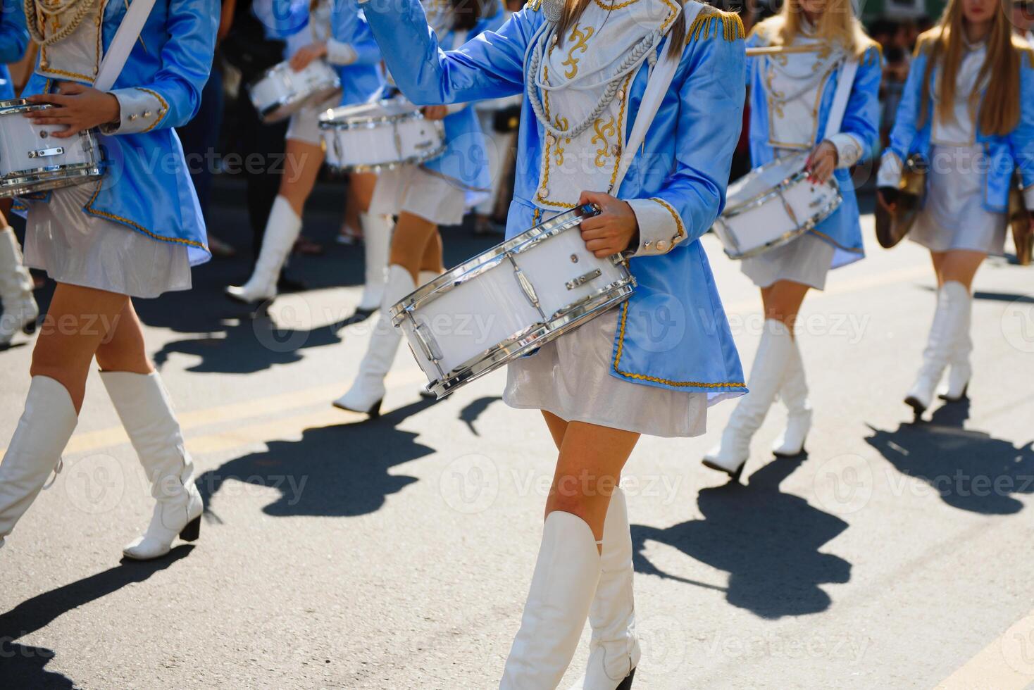 majorettes with white and blue uniforms perform in the streets of the city. photographic series photo