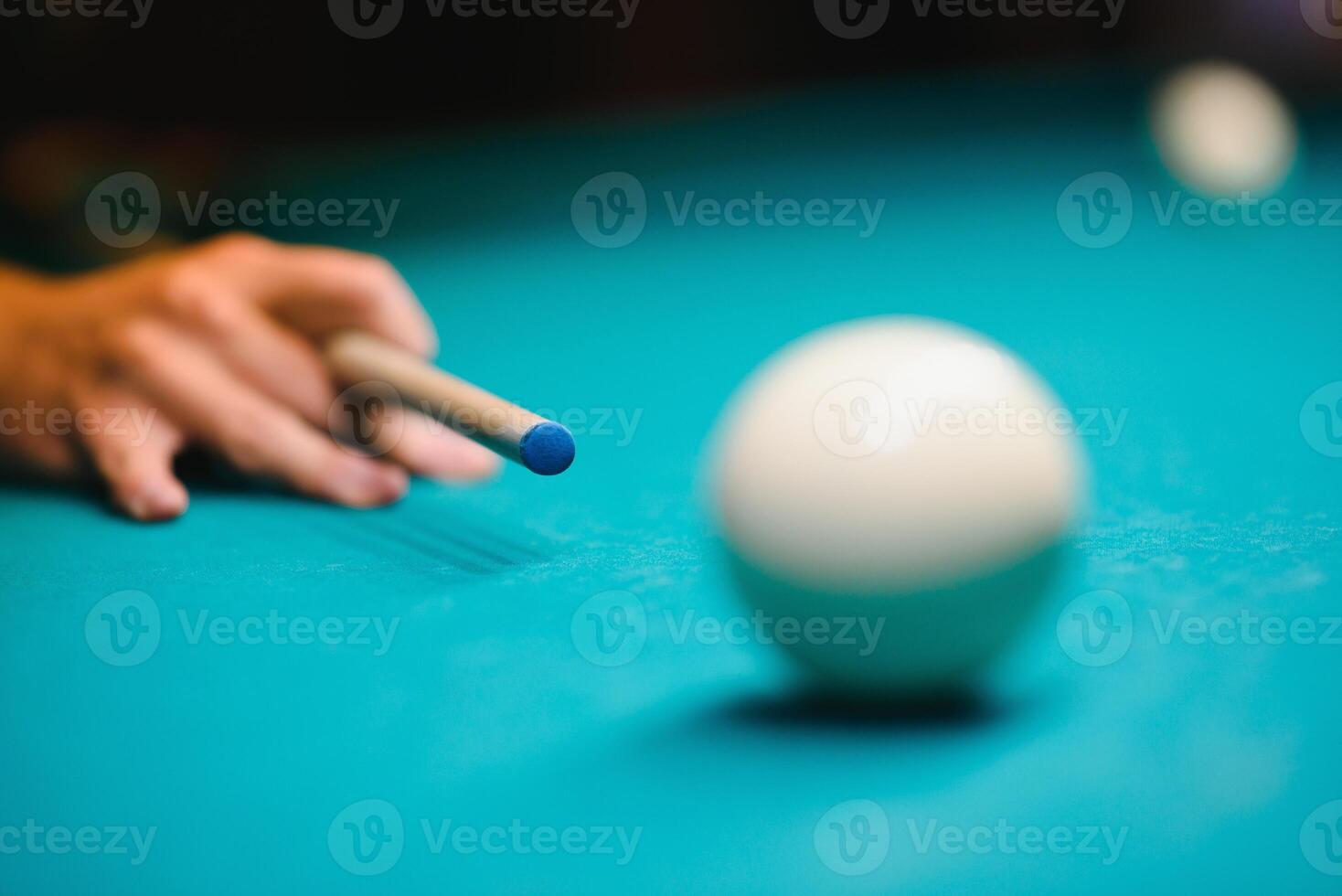 game of billiards the hand of a man with a billiard cue aims at a billiard ball photo