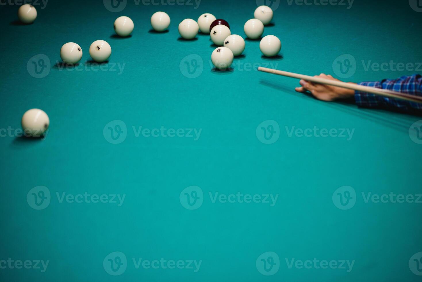 game of billiards the hand of a man with a billiard cue aims at a billiard ball photo