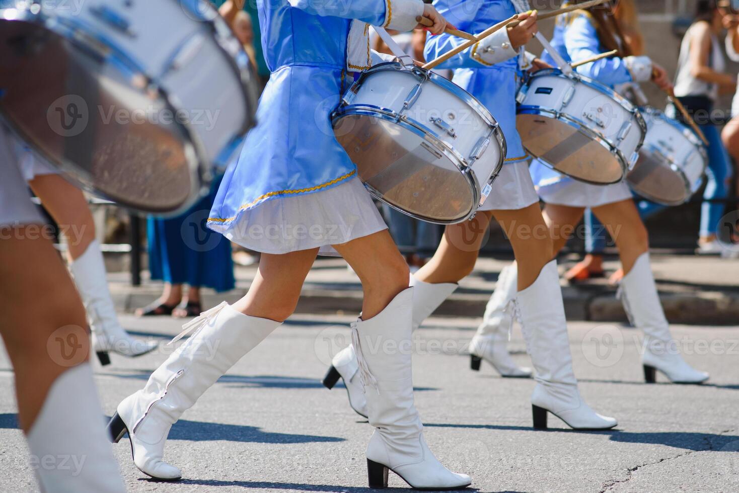 majorettes with white and blue uniforms perform in the streets of the city. photographic series photo