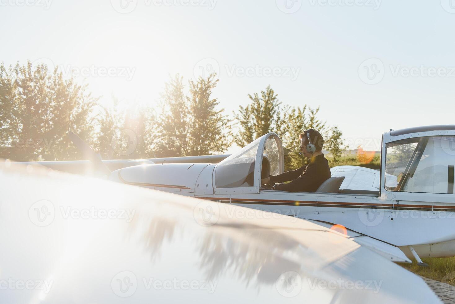 Young pilot is preparing for take off with private plane. photo