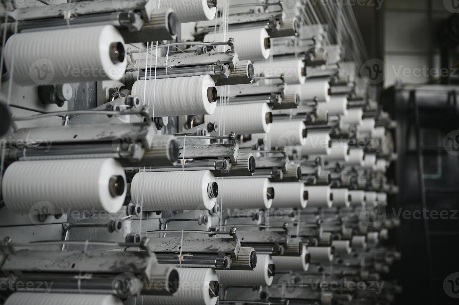 Coils of white flat polypropylene yarn for the production of industrial bags. circular loom woven bag machine. Production of polypropylene sleeves. photo