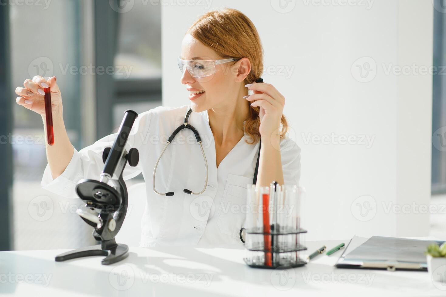 Scientist using a microscope in a laboratory, Testing for Coronavirus Covid19 vaccine photo