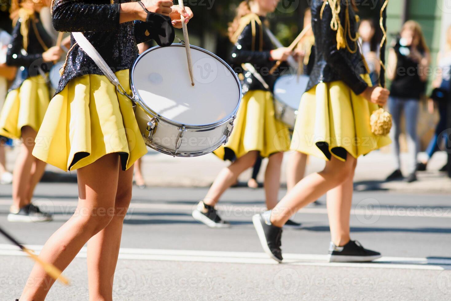 majorettes with white and blue uniforms perform in the streets of the city. photographic series photo