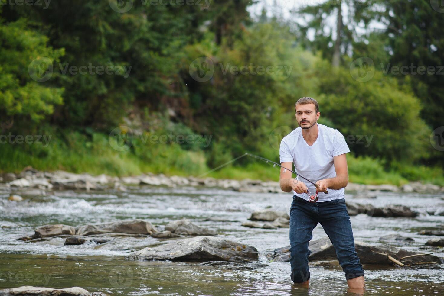 Man fly fishing casts on Irish river photo