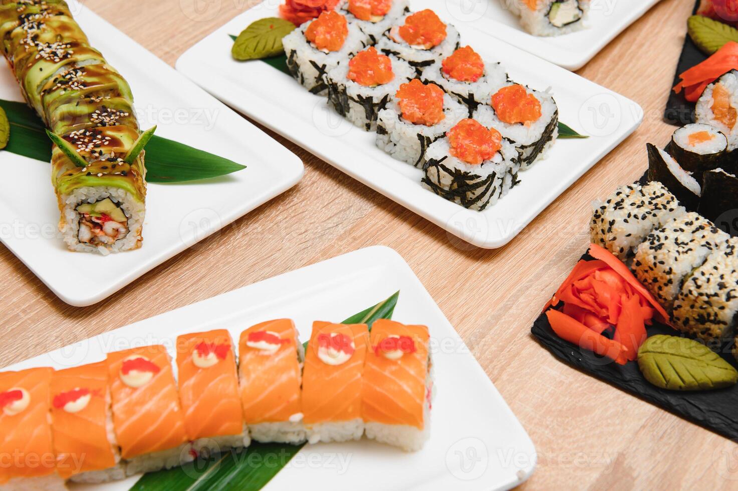 Japanese rolls on black background isolated with reflections photo