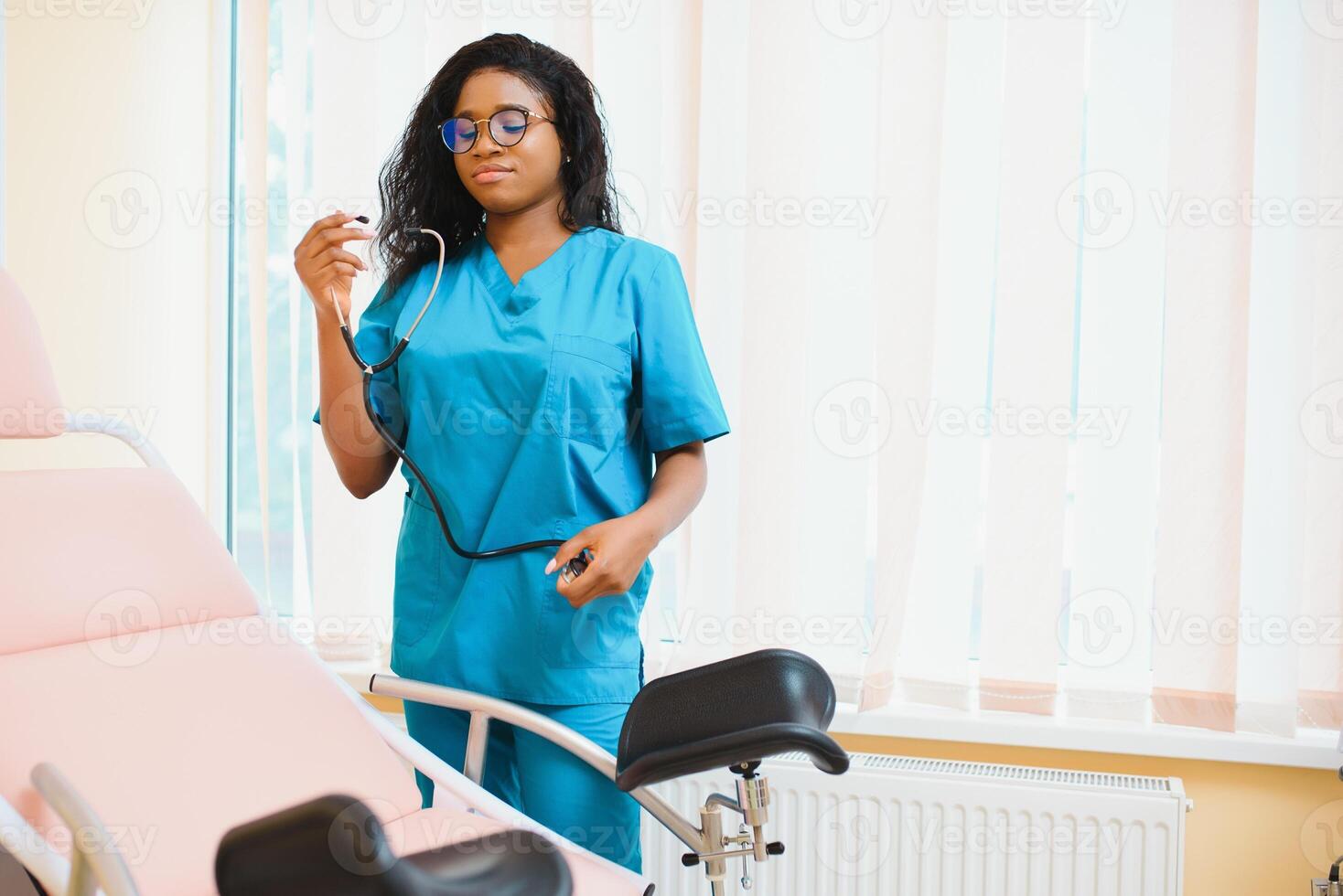 Professional female doctor on blurred consulting room background. African American gynecologist. Gynecology concept. photo