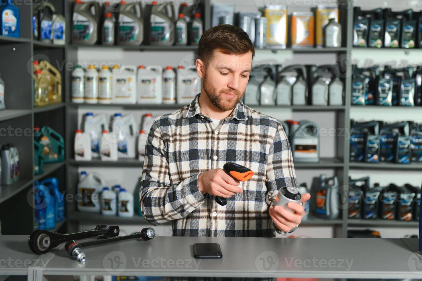 Portrait of a handsome salesman in an auto parts store. The concept of car repair photo