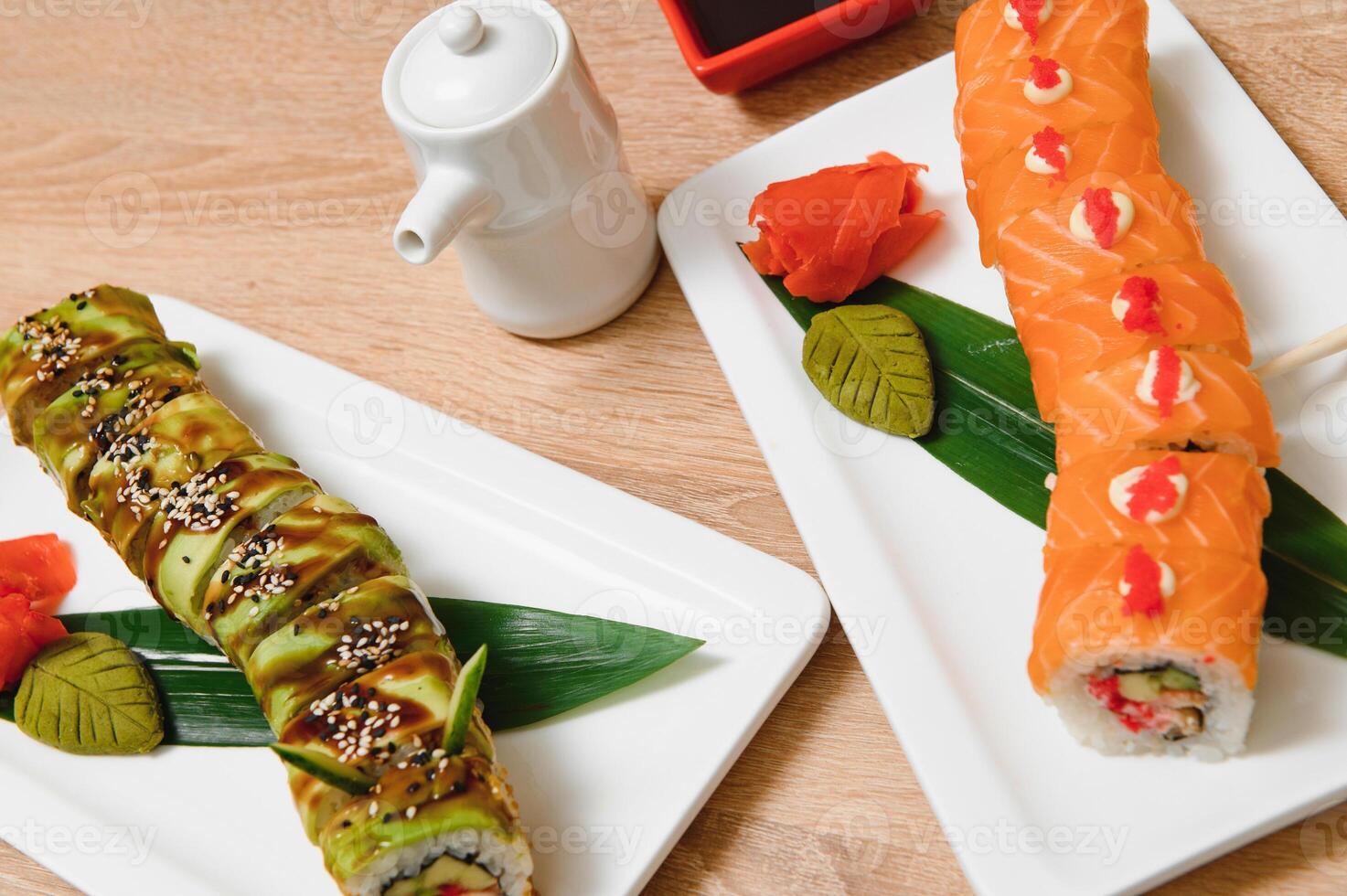 Japanese rolls on black background isolated with reflections photo
