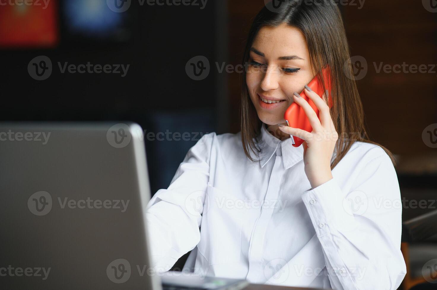 Confident business woman searching resume on site via laptop computer while sitting in restaurant during work break. Female project manager using applications on notebook device, resting in cafe photo
