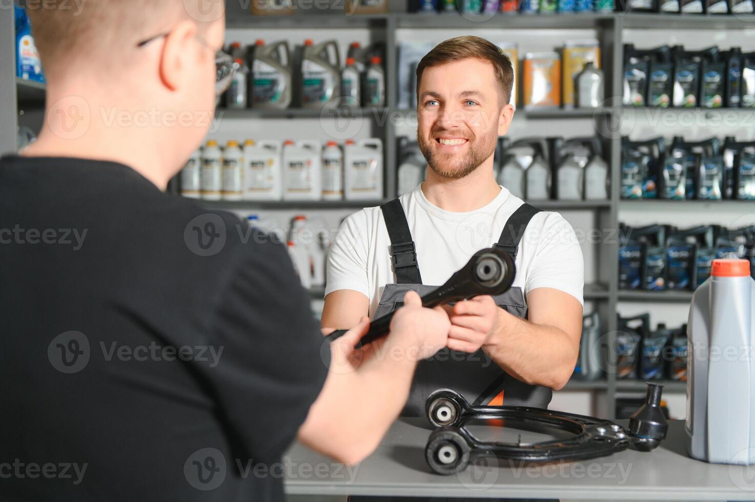 The seller selects new car repair parts for the client photo