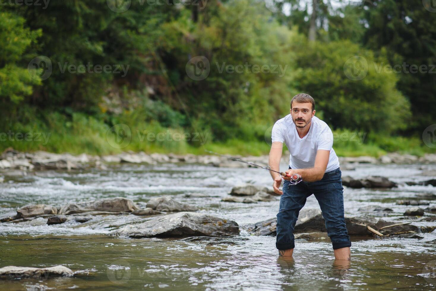 Man fly fishing casts on Irish river photo