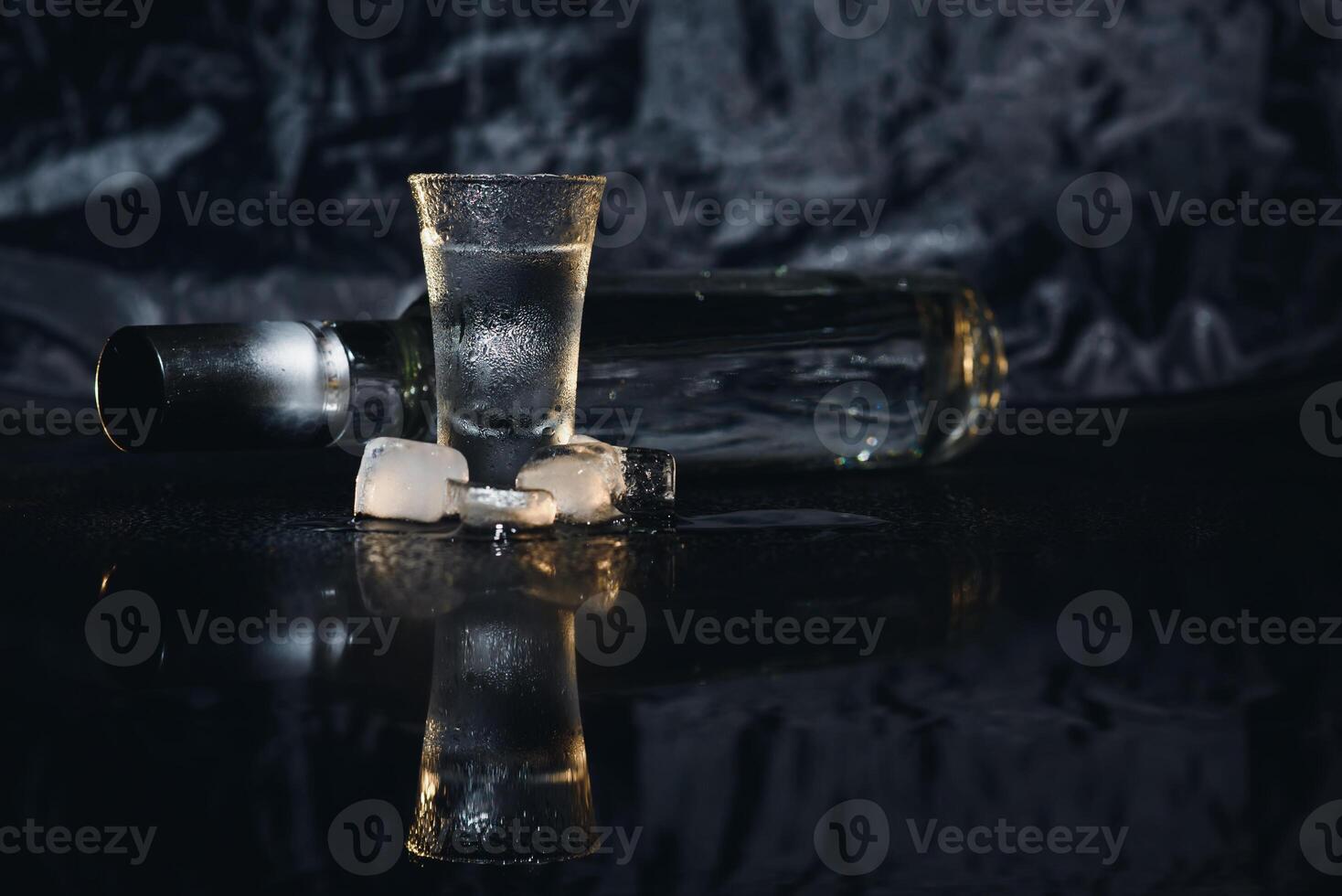 Vodka. Shots, glasses with vodka with ice .Dark background. Copy space .Selective focus. photo