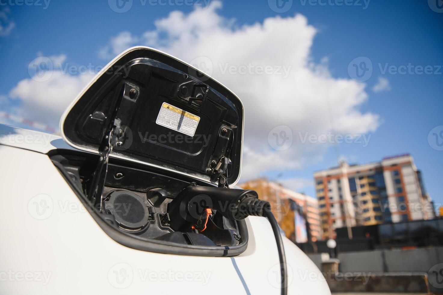 Charging modern electric car battery on the street which are the future of the Automobile, Close up of power supply plugged into an electric car being charged for hybrid . New era of vehicle fuel. photo