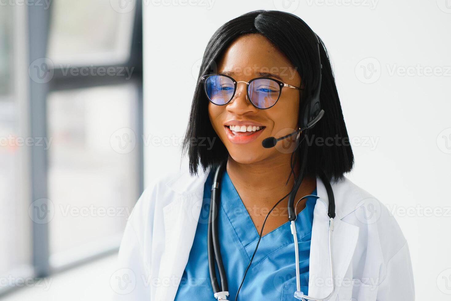 Young African-American doctor working on laptop in clinic. photo