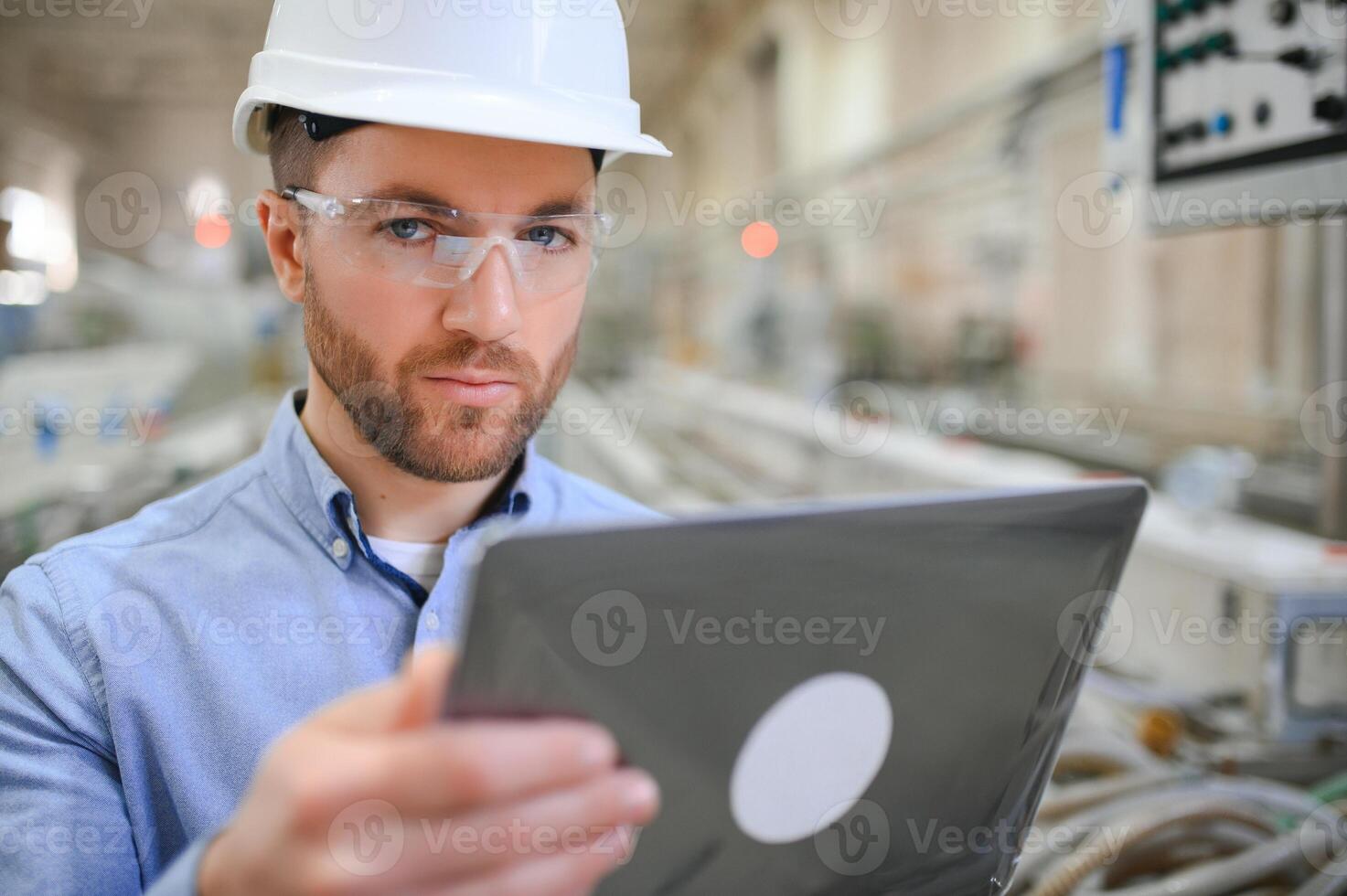 Portrait of confident handsome technical engineer in hardhat. photo