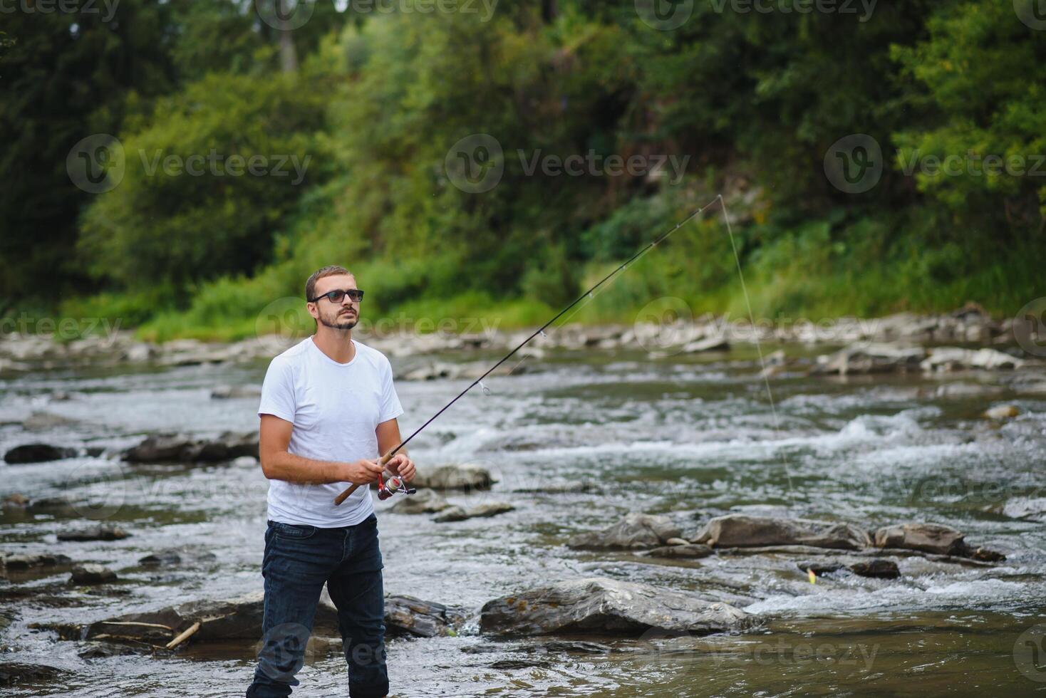 Man fly fishing casts on Irish river photo