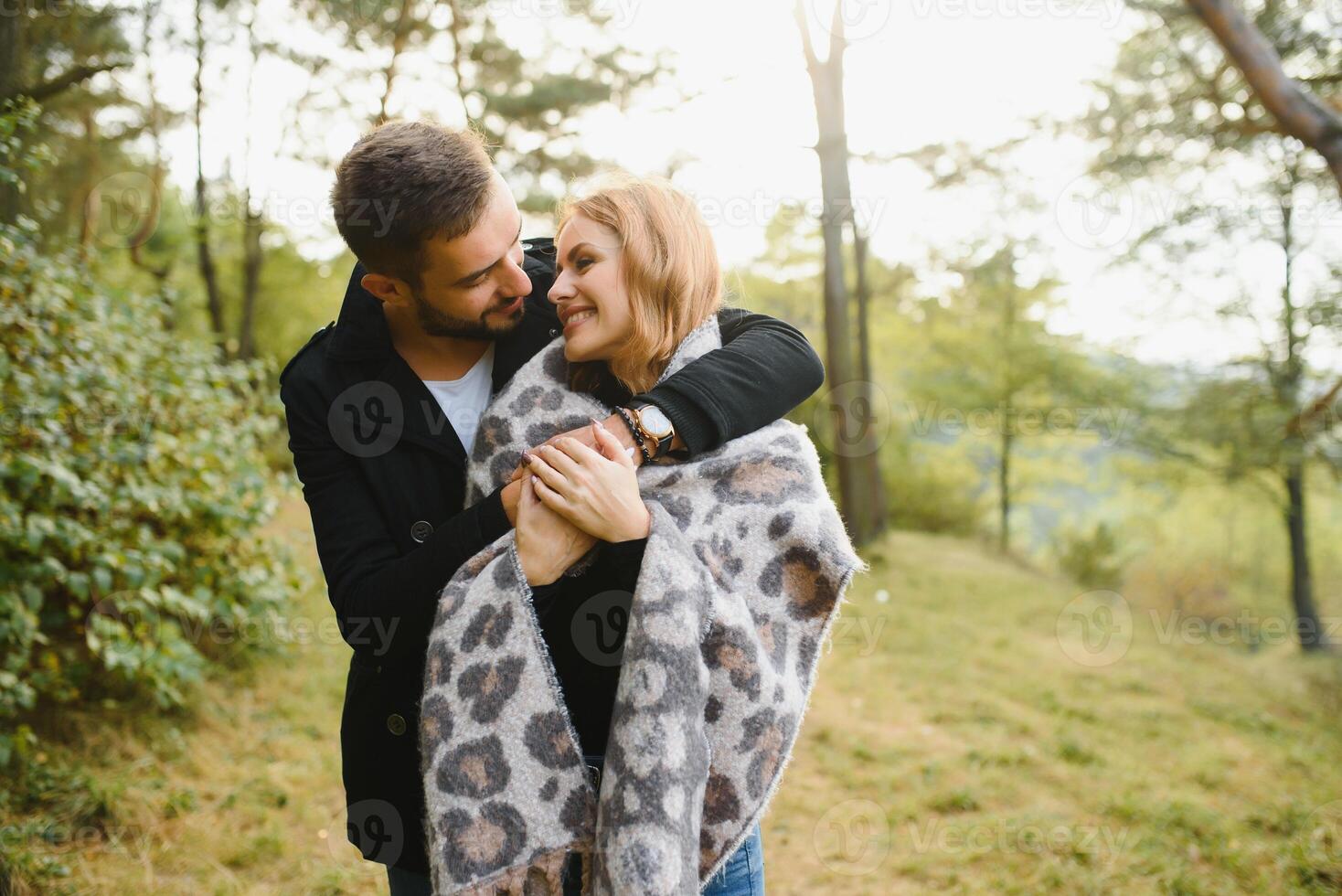 gentle and stylish couple are having a walk in the autumn park. photo