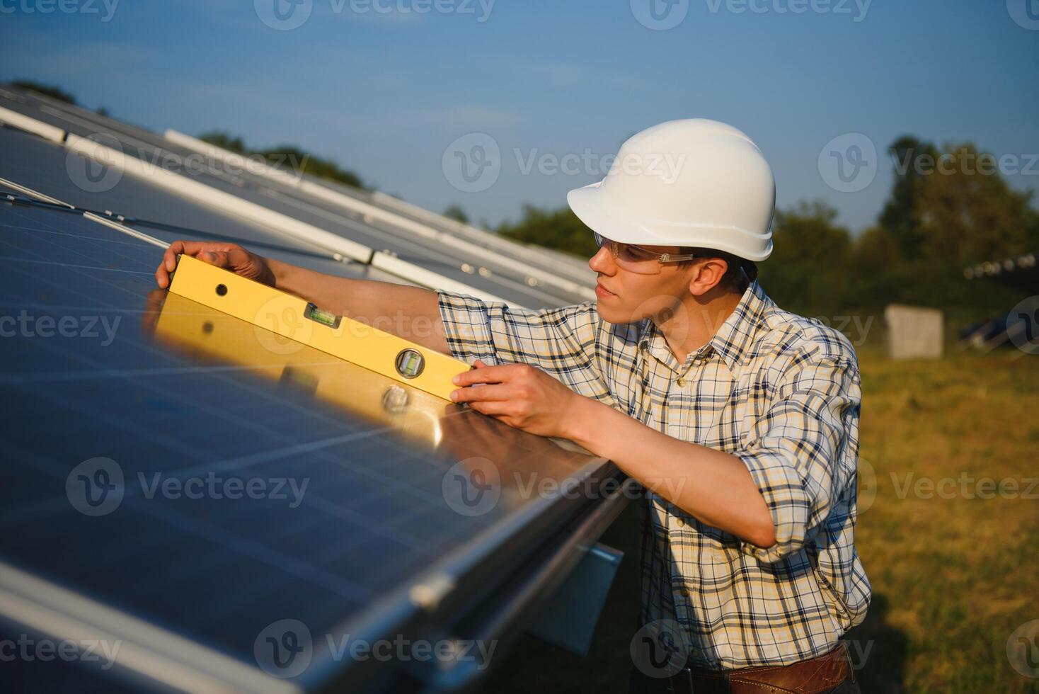 Worker installing solar panels outdoors photo