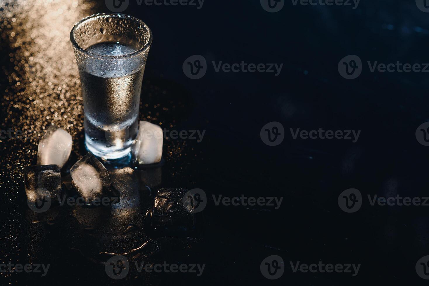 Vodka. Shots, glasses with vodka with ice .Dark background. Copy space .Selective focus. photo