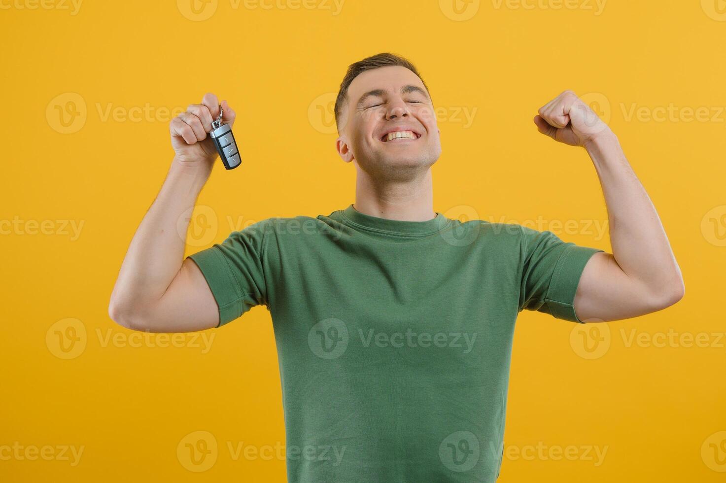 man with car keys on a yellow background, buying a new car photo